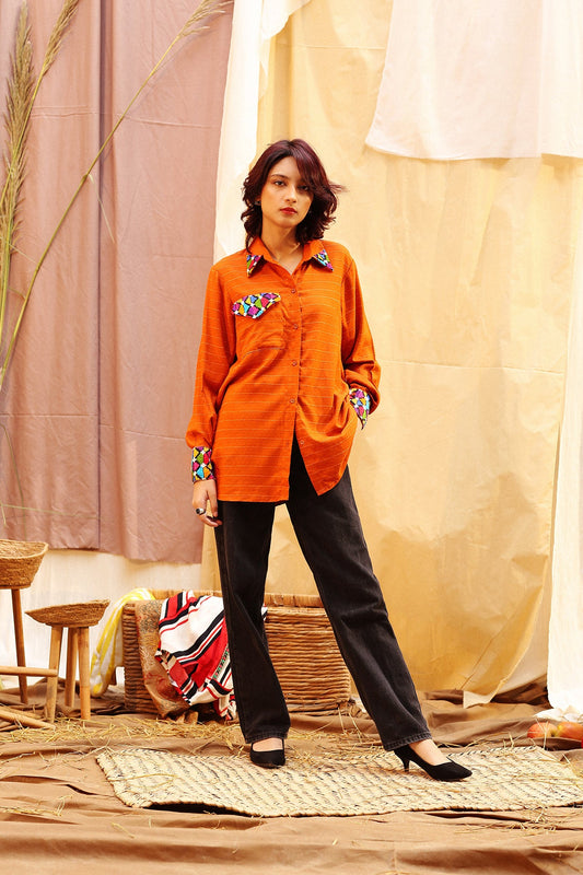 Crafted in a chic button down top with adstract embroidery on pocket ,sleeves and collar